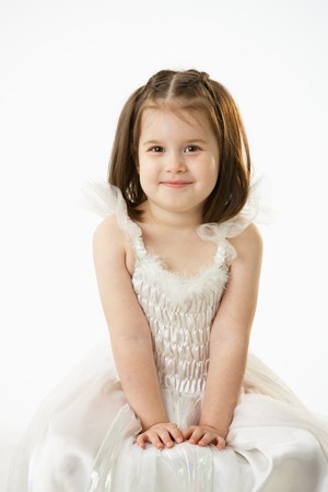 Portrait of cute little girl (4-5 years) wearing ballet costume looking at camera, smiling. Studio shot over white background.の写真素材