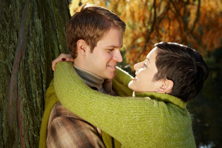 Loving couple embracing in autumn park.