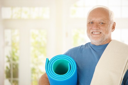 Portrait of sporty senior with polyfoam looking at camera, smilingの写真素材