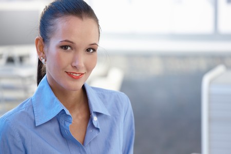 Portrait of attractive young businesswoman smiling at camera, copyspace.の写真素材