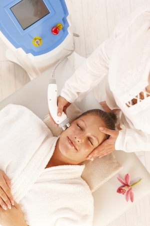 Young woman getting radio frequency cellulite treatment in day spa. Young woman getting radio frequency cellulite treatment in day spa.