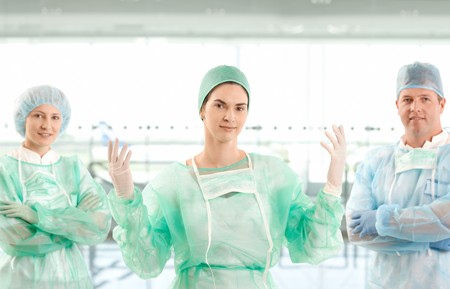 Portrait of smiling surgeon team looking at camera on hospital corridor.の写真素材