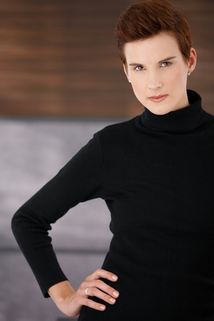 Portrait of trendy young woman posing confidentlyの写真素材