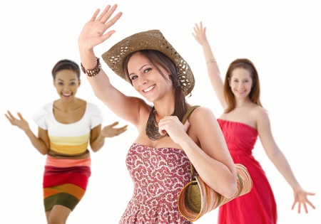 Group of happy young women waving hands in summer dresses.の写真素材