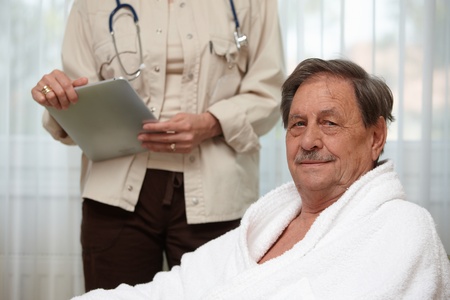 Mature man at health control, looking at camera.の写真素材
