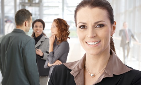 Closeup portrait of young businesswoman smiling happy on the street.の写真素材