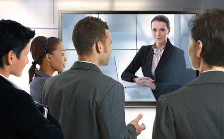 Young businesspeople and businesswoman having video call at office. LCD display. 