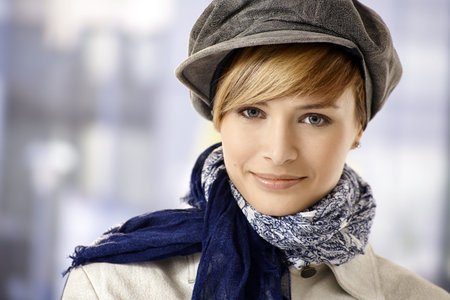 Closeup portrait of attractive young woman wearing cap 