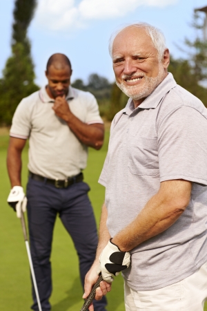 Happy senior man golfing, smiling.の写真素材