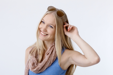 Summer portrait of happy young woman, smiling, looking away.の写真素材