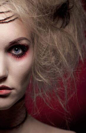 Half-portrait of blonde woman in Halloween makeup, looking at camera.の写真素材