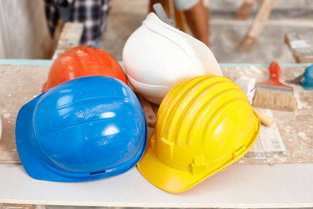 Closeup photo of hardhats of different colours.の写真素材