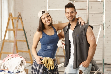 Happy young attractive couple renewing home, smiling happy.の写真素材