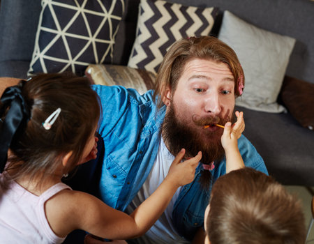 Father and children playing at home, having fun.の写真素材