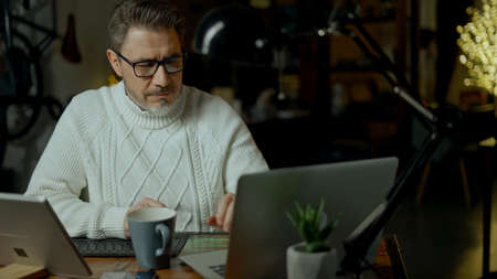 Man working with laptop computer in home officeの写真素材