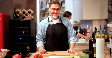 Caucasian man cooking in the kitchen at home.の写真素材