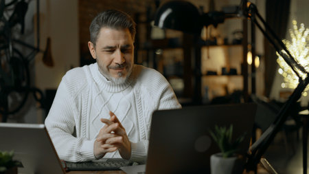 Man working online with computer in home office