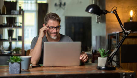 Man working with laptop at home officeの写真素材