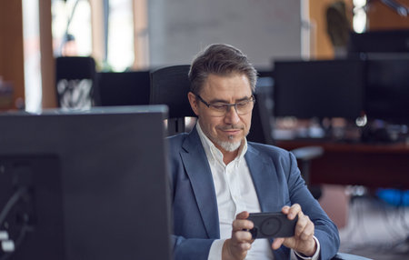 Business portrait - Businessman sitting at desk in office.の写真素材
