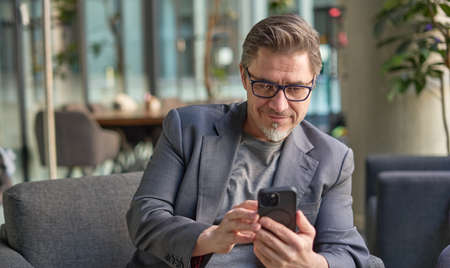 Businessman working online with phoneの写真素材