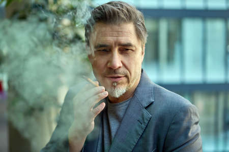 Portrait of man smoking cigarの写真素材
