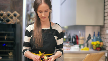 Woman cooking in kitchen at homeの写真素材