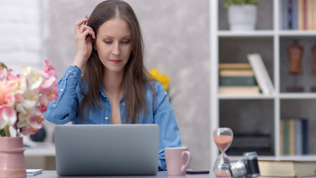 Woman working with laptop at home officeの写真素材
