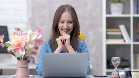 Woman working with laptop at home officeの写真素材