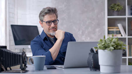 Man working with laptop at home officeの写真素材