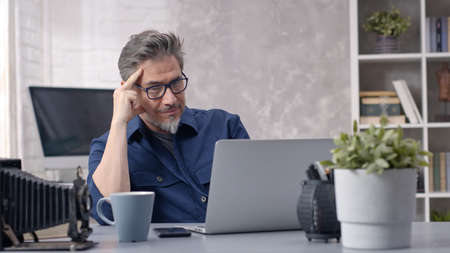 Man working with laptop at home officeの写真素材