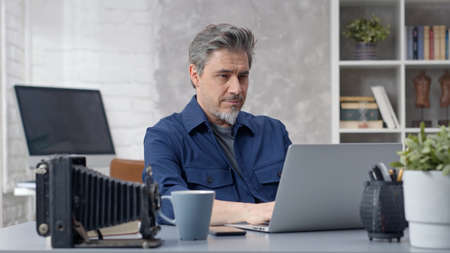 Man working with laptop at home officeの写真素材