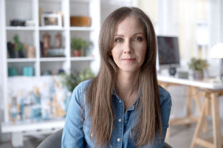Portrait of happy young woman at homeの写真素材