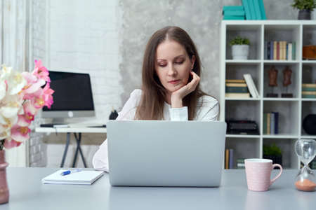 Businesswoman working with laptop at officeの写真素材