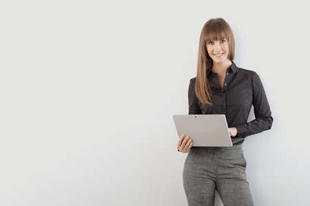 Happy young businesswoman with laptop computerの写真素材