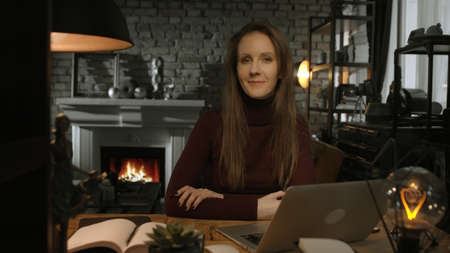 Home office - woman working from home in dark roomの写真素材