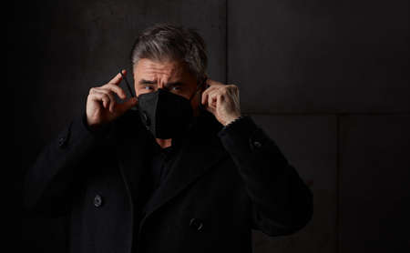 Portrait of older man in 50s wearing face maskの写真素材