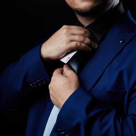 Magician illusionist showing performing card trickの写真素材