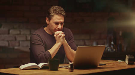 Man working with laptop computer at home officeの写真素材