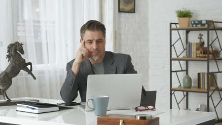 Older man working at home officeの写真素材