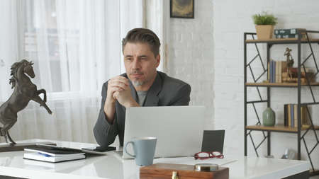 Older man working at home officeの写真素材