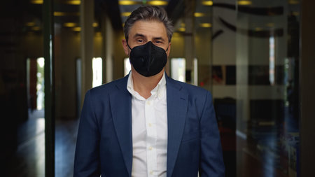 Covid-19 - businessman in face mask in business office