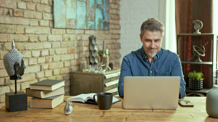 Man working with laptop computer at home officeの写真素材