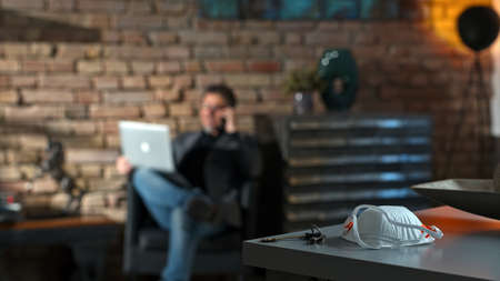 Home office - virus protective mask on deskの写真素材