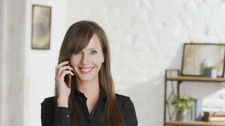 Portrait of confident woman on the phoneの写真素材
