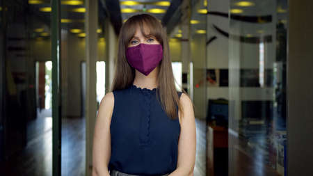 Covid-19 - businessman in face mask in business officeの写真素材