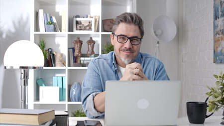 Man working with laptop at home officeの写真素材