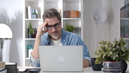 Man working with laptop at home officeの写真素材