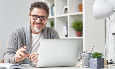 Man working with laptop at home officeの写真素材