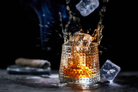 Glass of whiskey and smoking cigarの写真素材