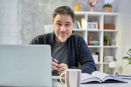 Man working with laptop at home officeの写真素材
